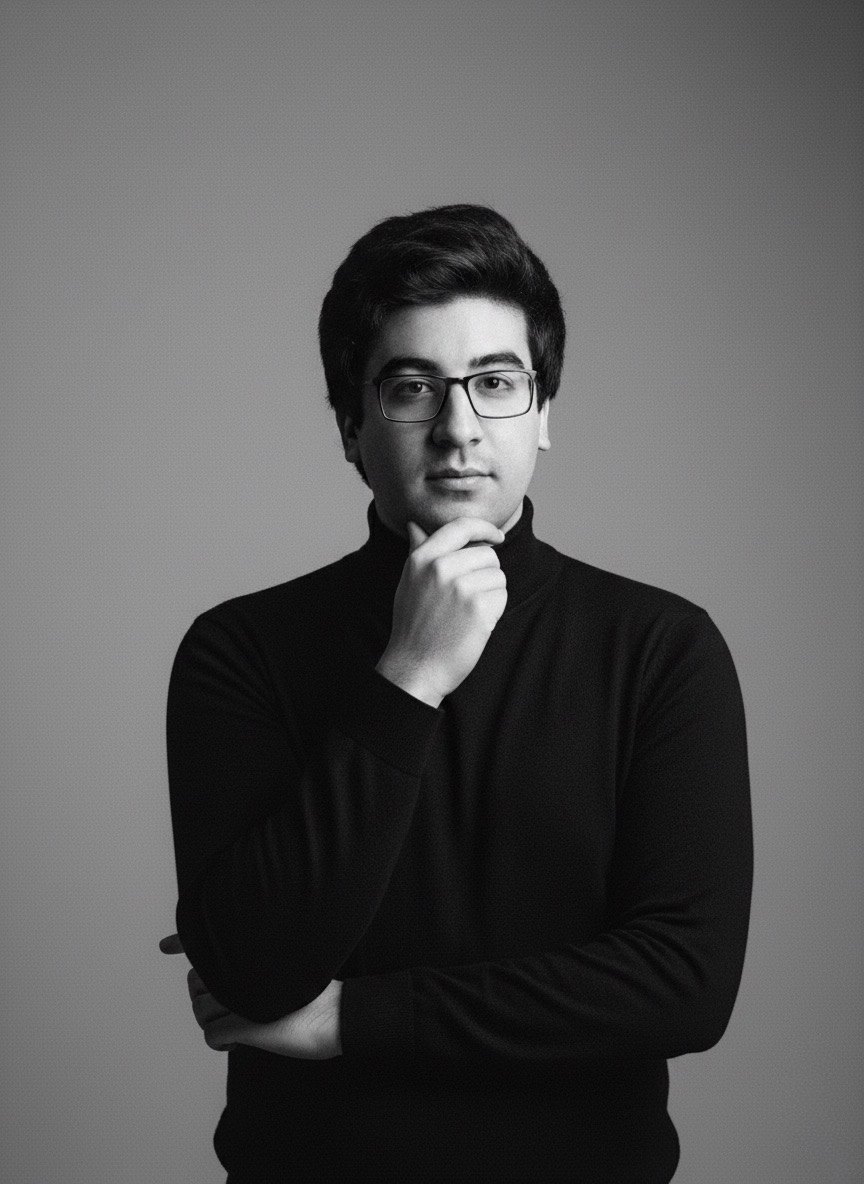Abdulrahman Elhelaihy in a black turtleneck, hand at his chin, black and white portrait